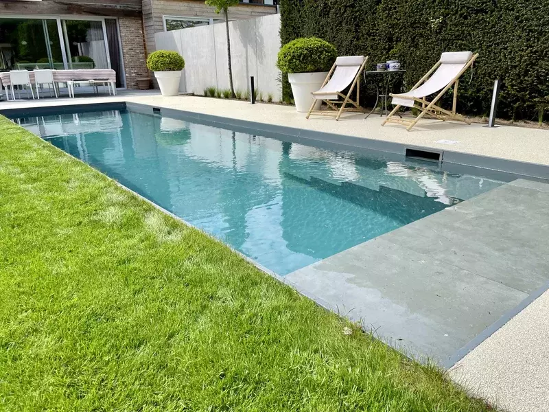 Energiezuinig overloopzwembad met boordstenen aangelegd door Upgrade Pools in Zwevegem
